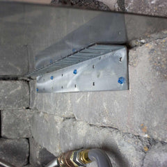 Warming Trends 19-Inch Paver Collar installed in a fire pit enclosure below a burner plate